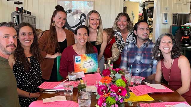 People gathered at a restaurant posing.