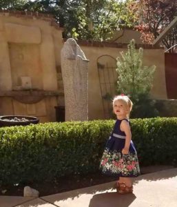 Little girl in dress in the patio at The Compound in Santa Fe, New Mexico.