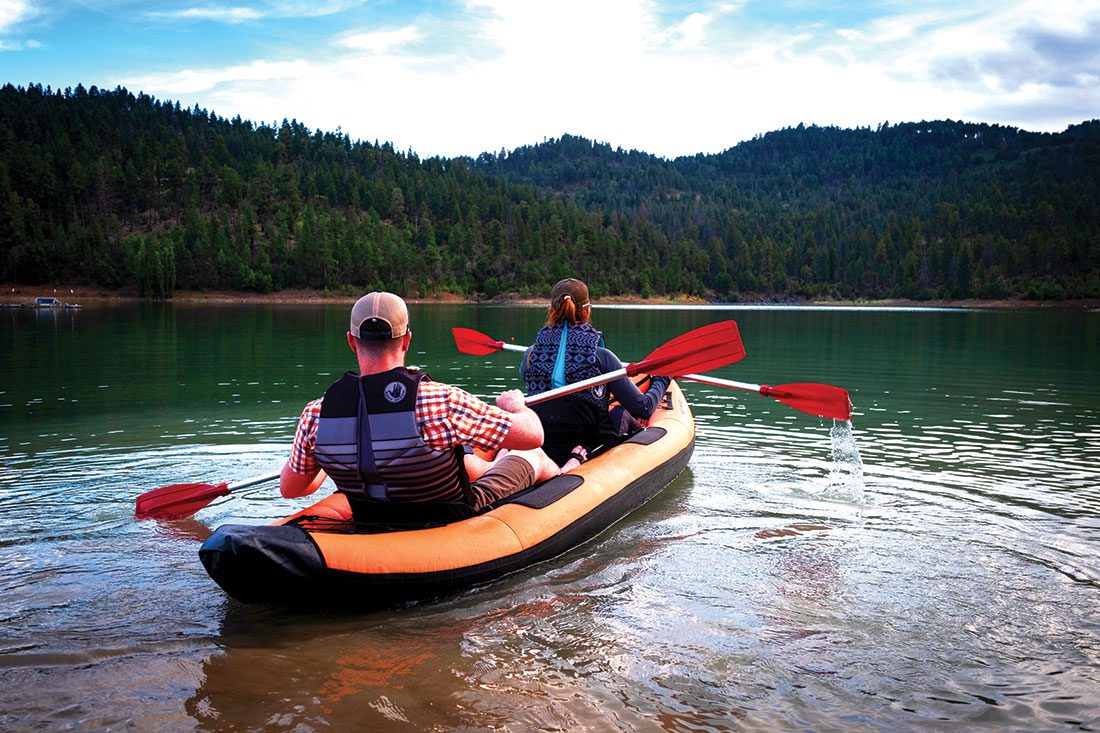 Couple kayaking at Grindstone Lake during a camping trip.