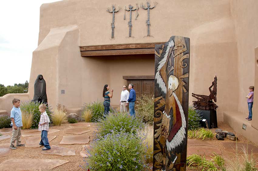 Visitors in the sculpture garden at Museum of Indian Arts & Culture. Photograph by Kitty Leaken.