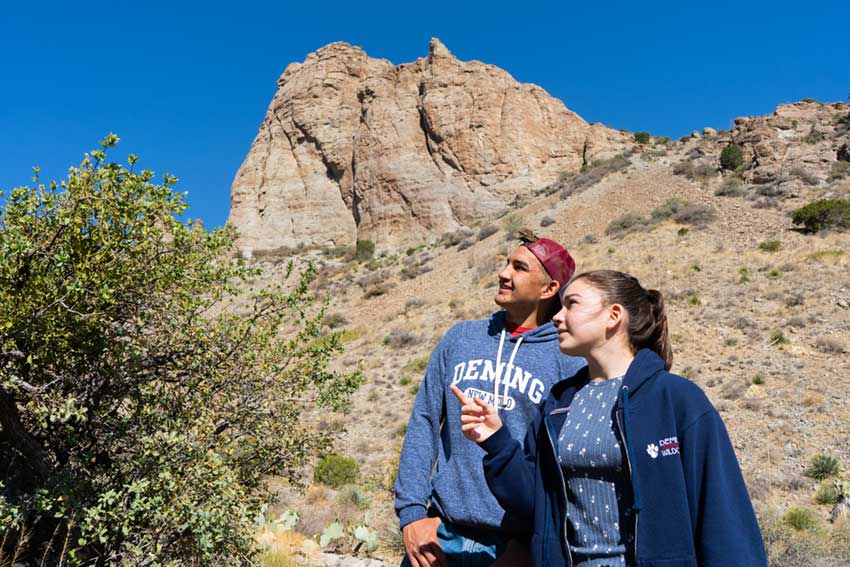 A man and woman hiking at a New Mexico state park.