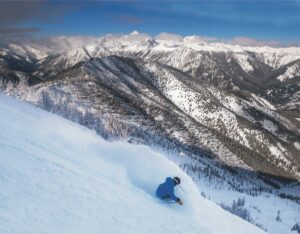 Skier in blue jacket going downhill at Panorama.