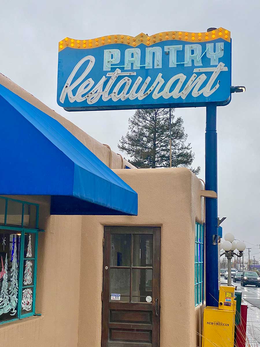 The front of the Pantry Restaurant features a blue awning and sign from decades past.