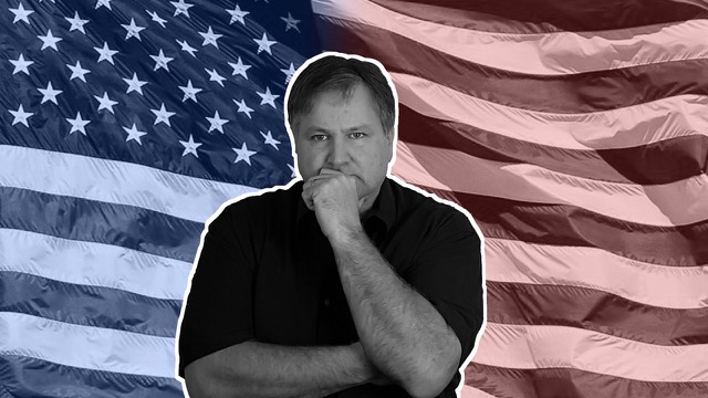 Rick Smith in front of flag.