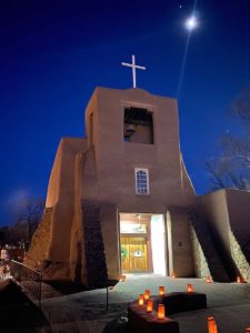 Exterior of San Miguel Chapel with luminarias.