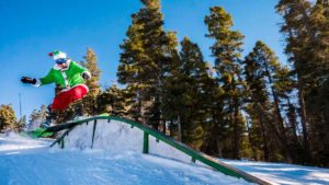 At another special ski event, the Grinch-Santa enjoys a snow day in the excellent terrain park found at Angel Fire Resort. Photo courtesy AFR.