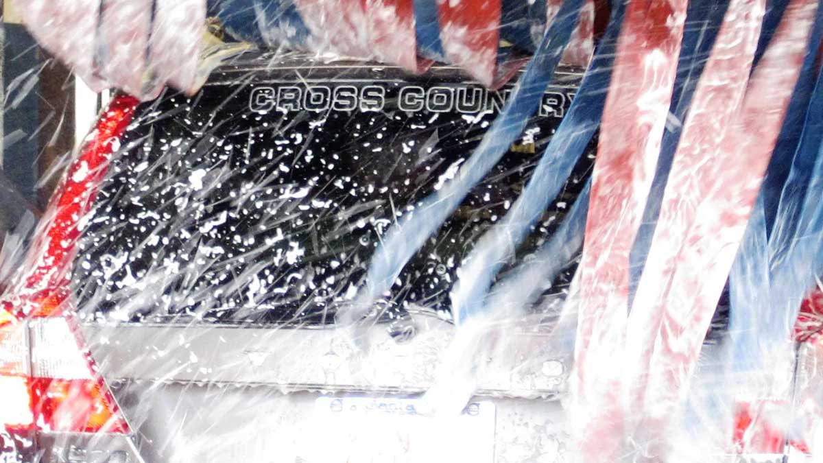 Squeaky Clean Car Wash with a car going through the wash.