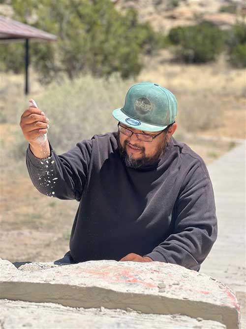 Artist Walter Torres creating a sculpture to be on display in the parking lot at the El Malpais NCA Ranger Station.