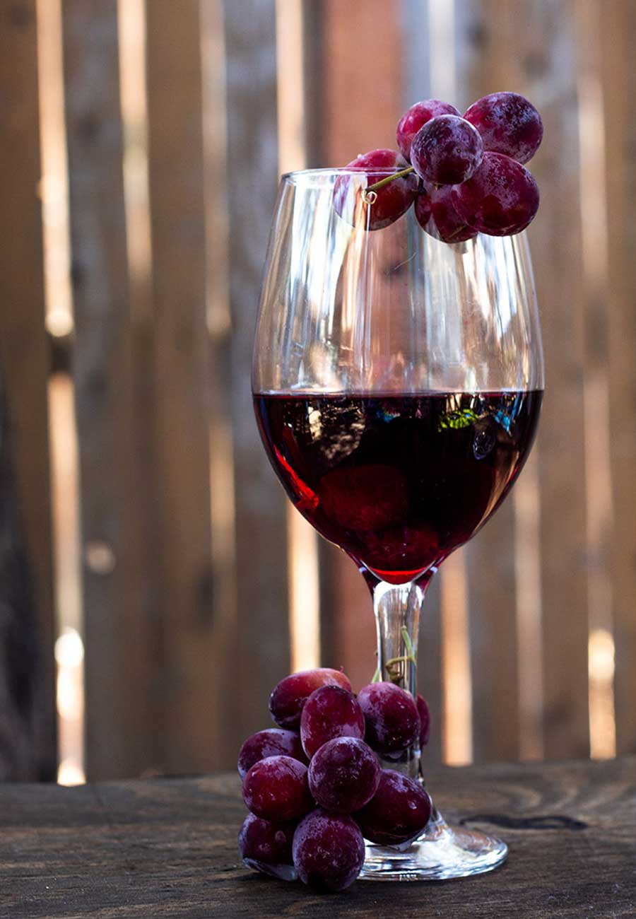 Glass of wine with frozen grapes